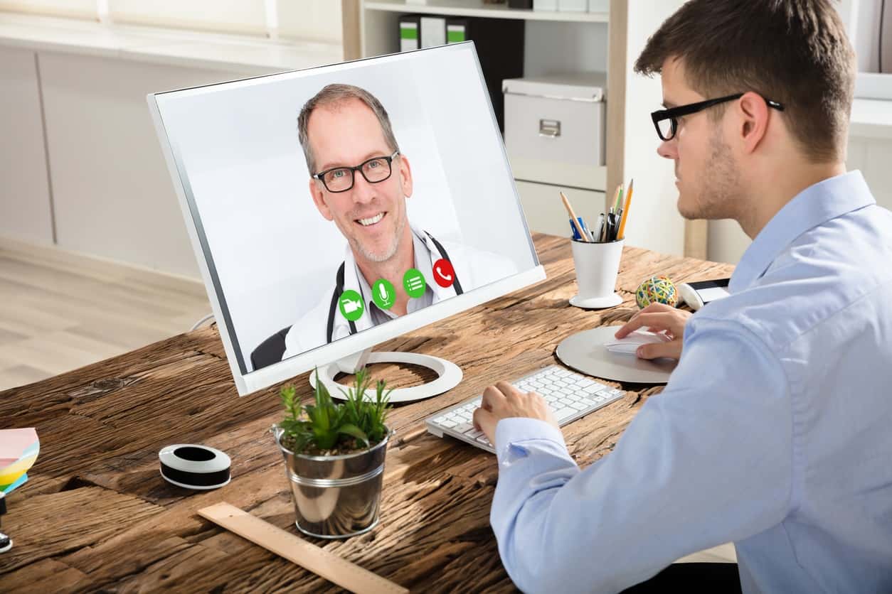 Businessman Video Conferencing With Doctor On Computer - Regional One ...